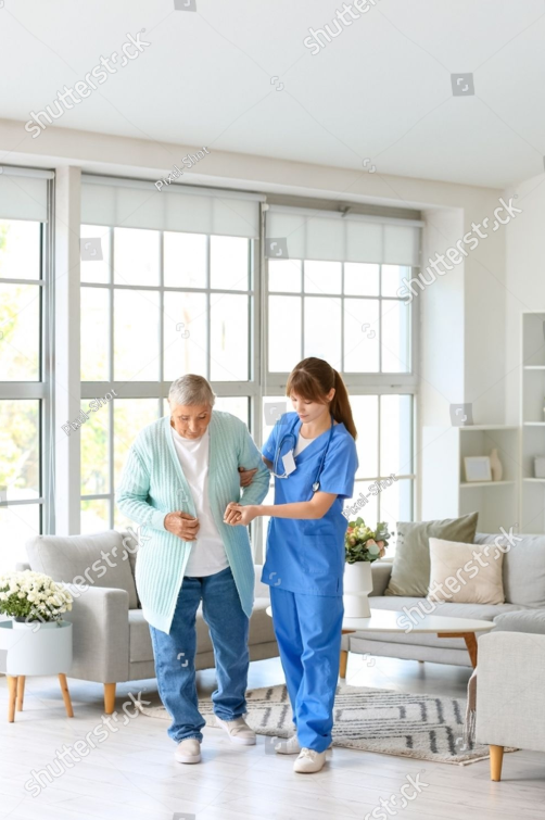 shutterstock-young-caregiver-helping-senior-woman-walk-2390412713